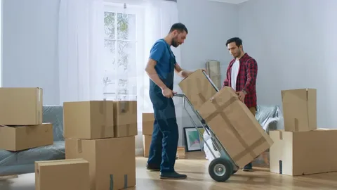 Illustration of a happy family moving into a new home with packed boxes, a moving truck, and household items, representing 10 smart moving tips from BetterMoves for an easy and stress-free home relocation.